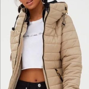 Pretty Little Thing tan puffy jacket.